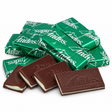 Andes mints in green foil wrappers with unwrapped chocolate mint layers