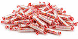 Bulk Smarties candy rolls, individually wrapped, poured out showing colorful assortment